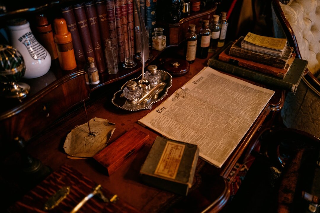 Person writing in a journal at a wooden desk