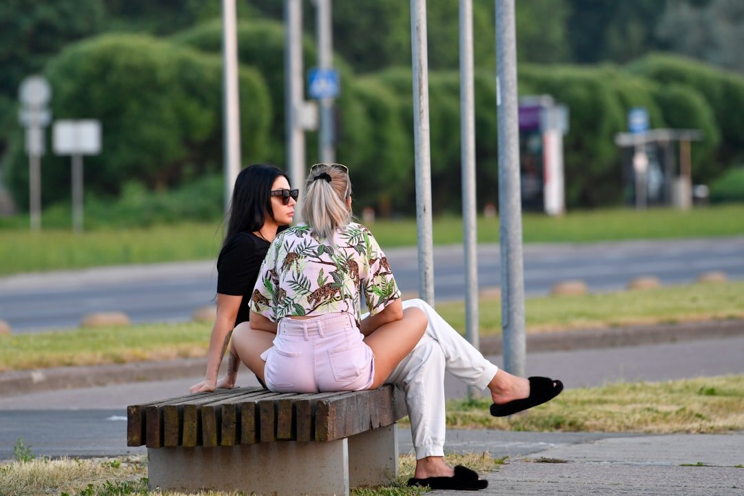 two friends talking on bench