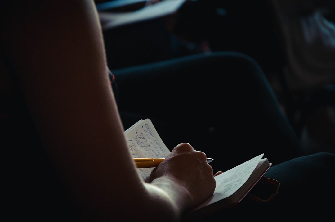 person writing in journal