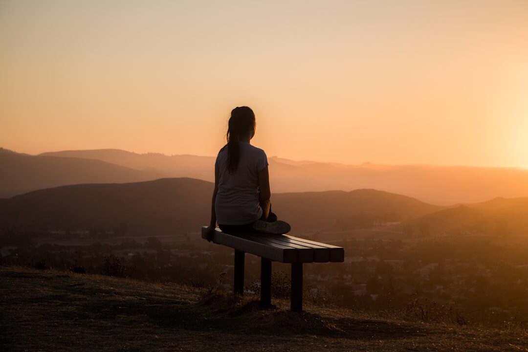 person meditating at dawn